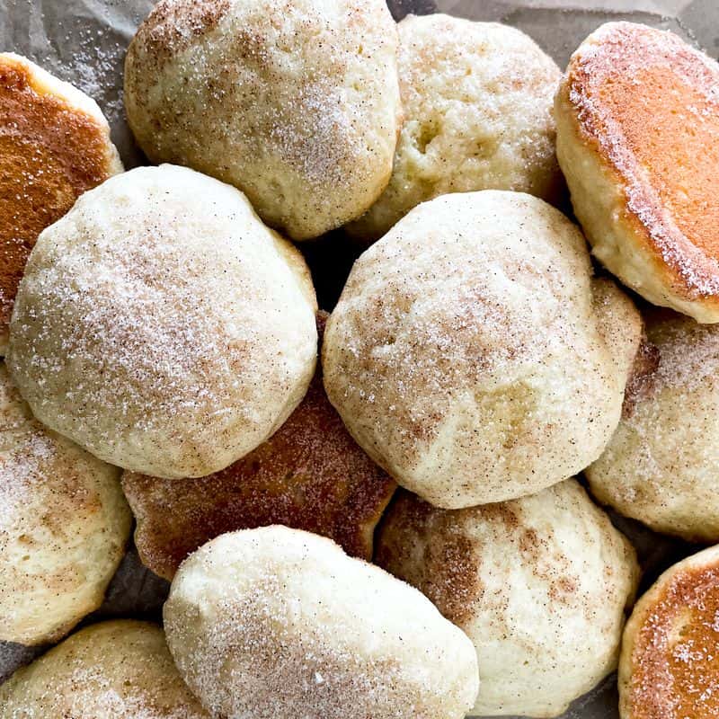 several buttermilk cookies laying on top of each other in a pile