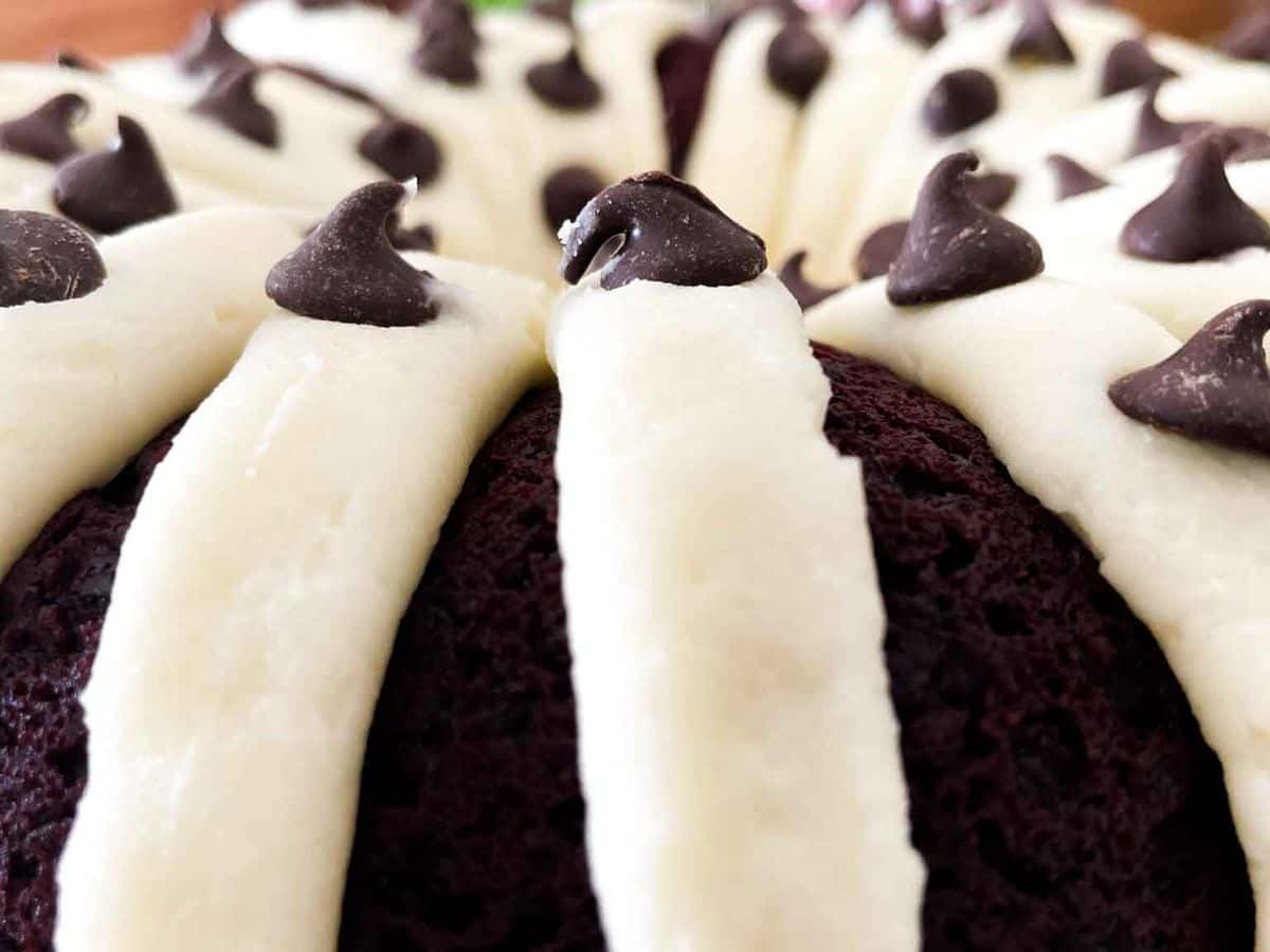 closeup of frosting and chocolate chips on red velvet bundt cake
