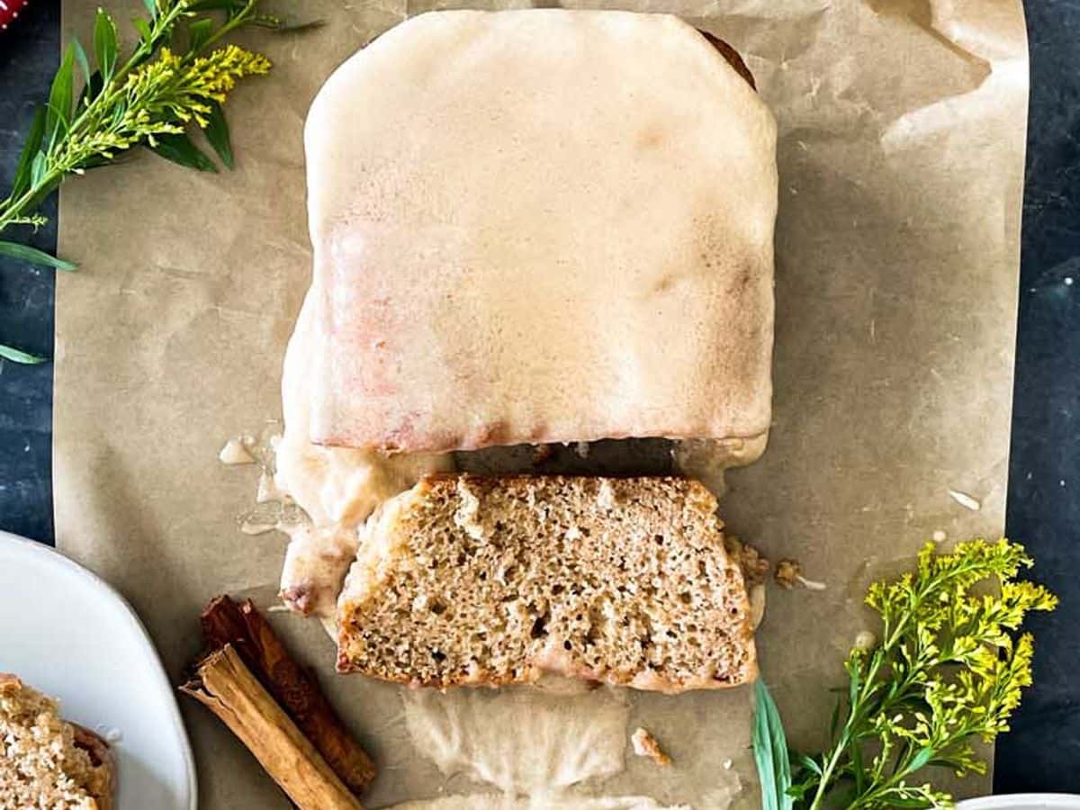 loaf of apple cider donut bread with slice cut and on plate