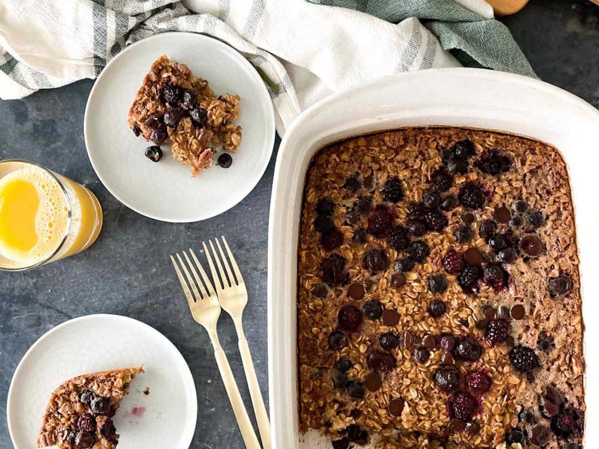 baked oatmeal with berries in casserole dish and on plates