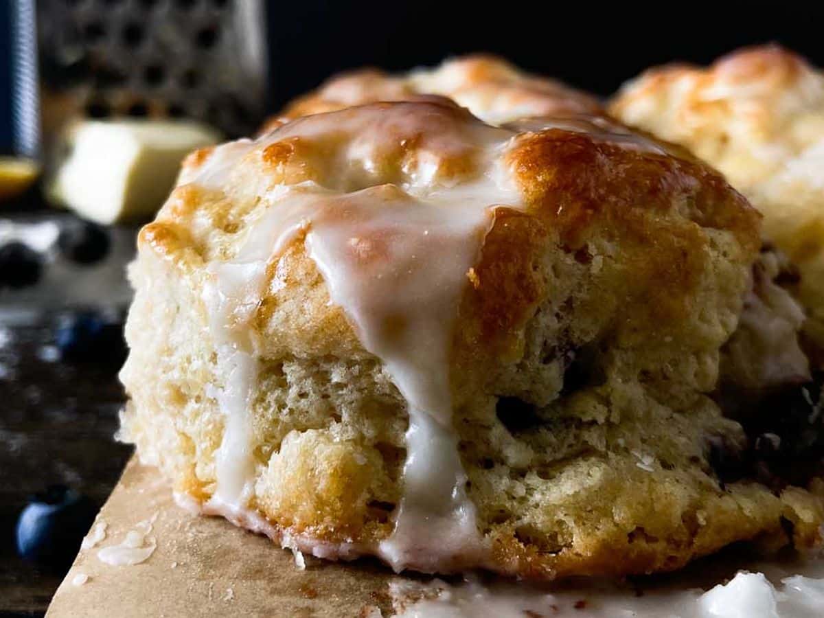 boberry biscuits with blueberries and icing closeup of a single biscuit from the side