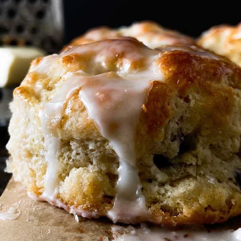 boberry biscuits with blueberries and icing closeup of a single biscuit from the side