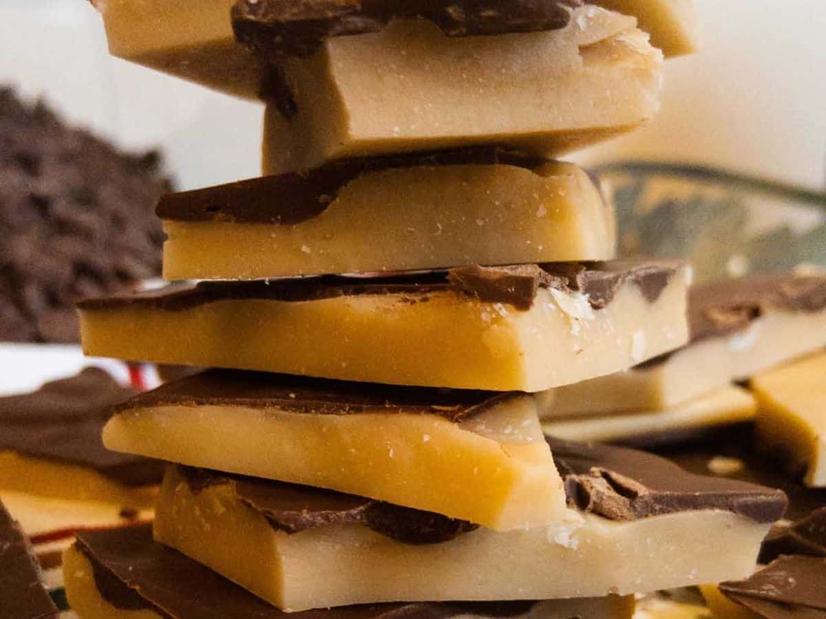 pieces of buttercrunch with chocolate topping stacked on top of each other