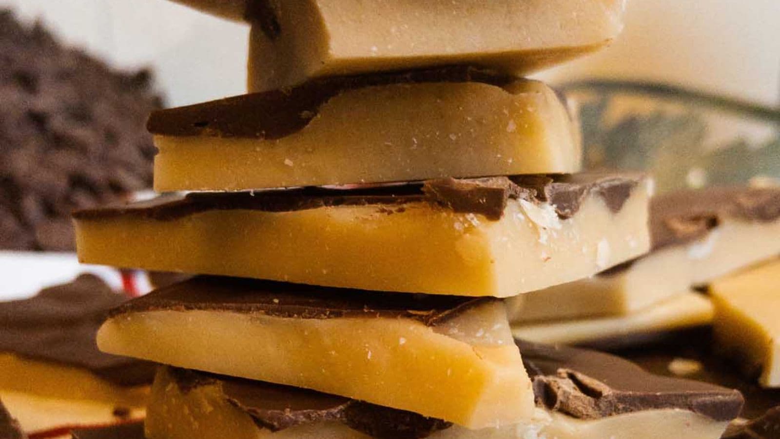 pieces of buttercrunch with chocolate topping stacked on top of each other