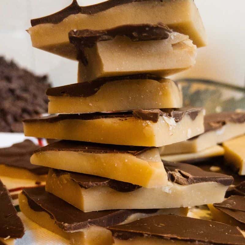 pieces of buttercrunch with chocolate topping stacked on top of each other