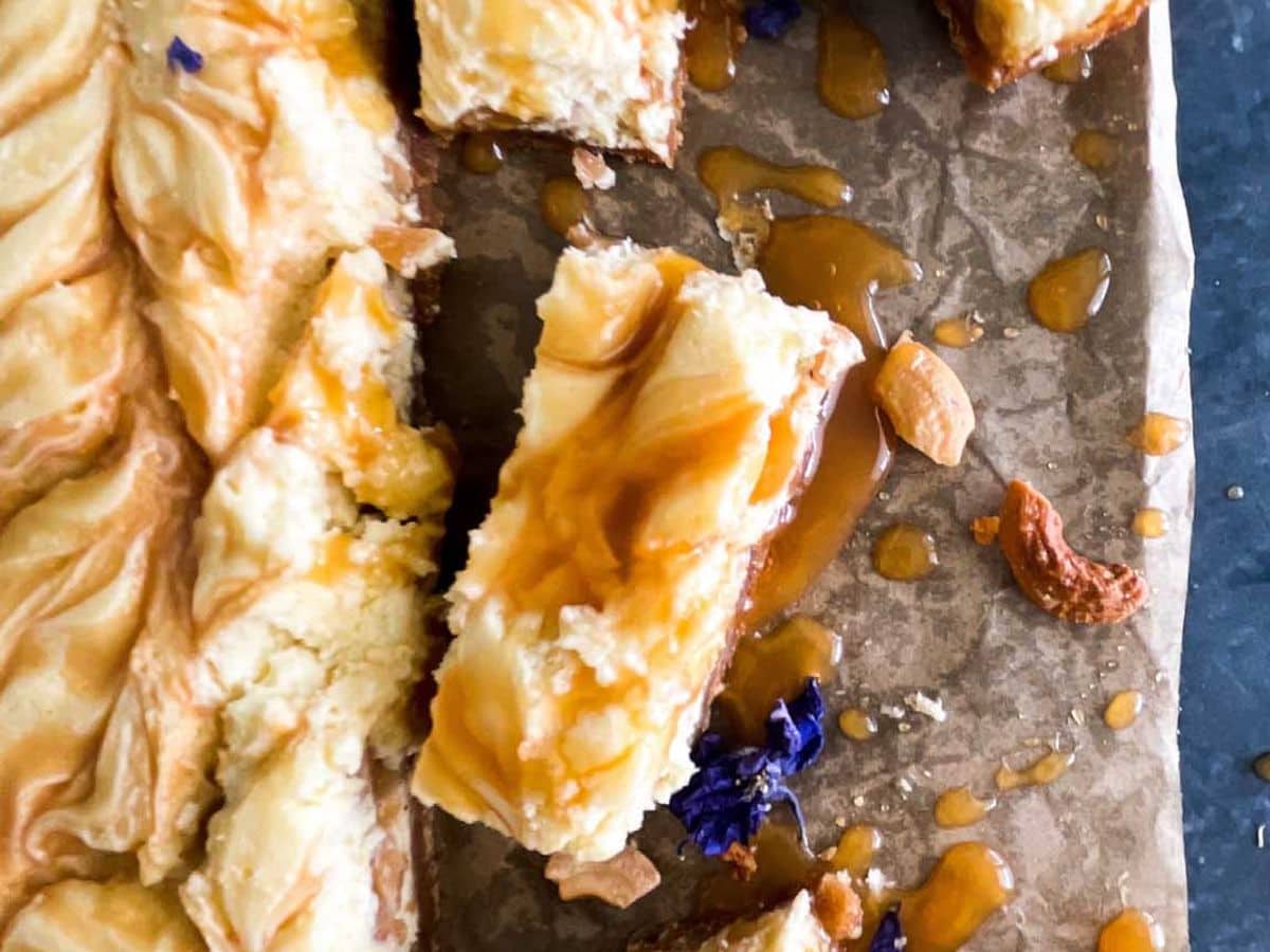 caramel cashew cheesecake cut into bars