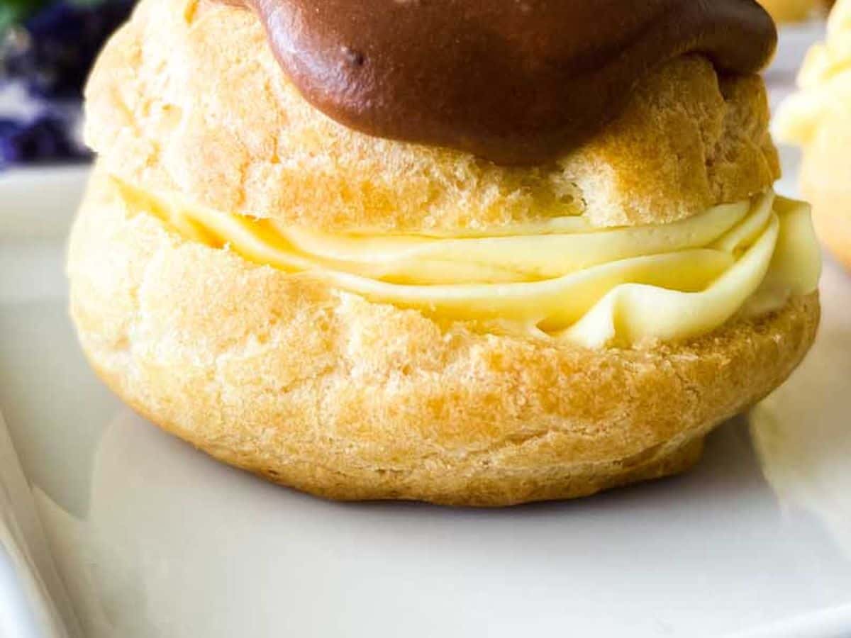 chocolate eclair on a white serving tray