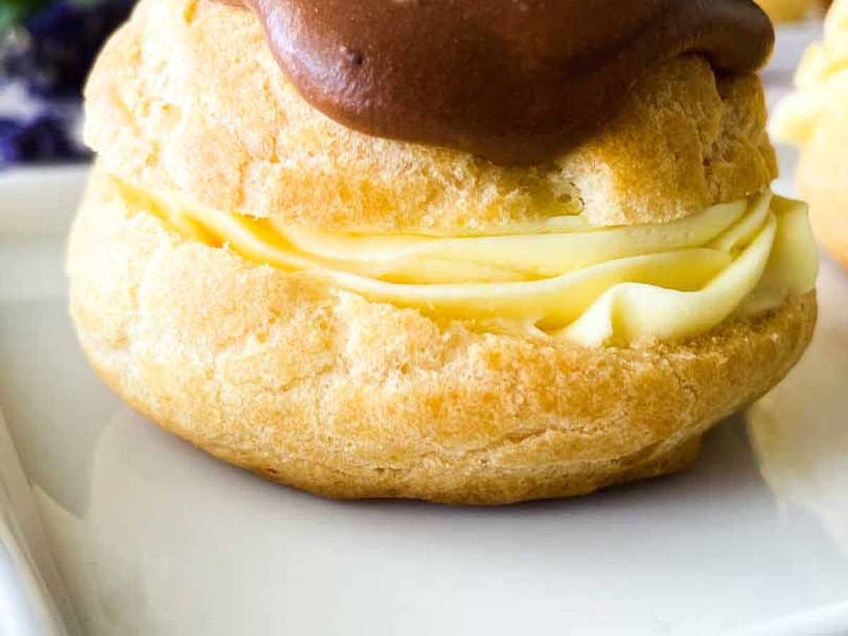 chocolate eclair on a white serving tray