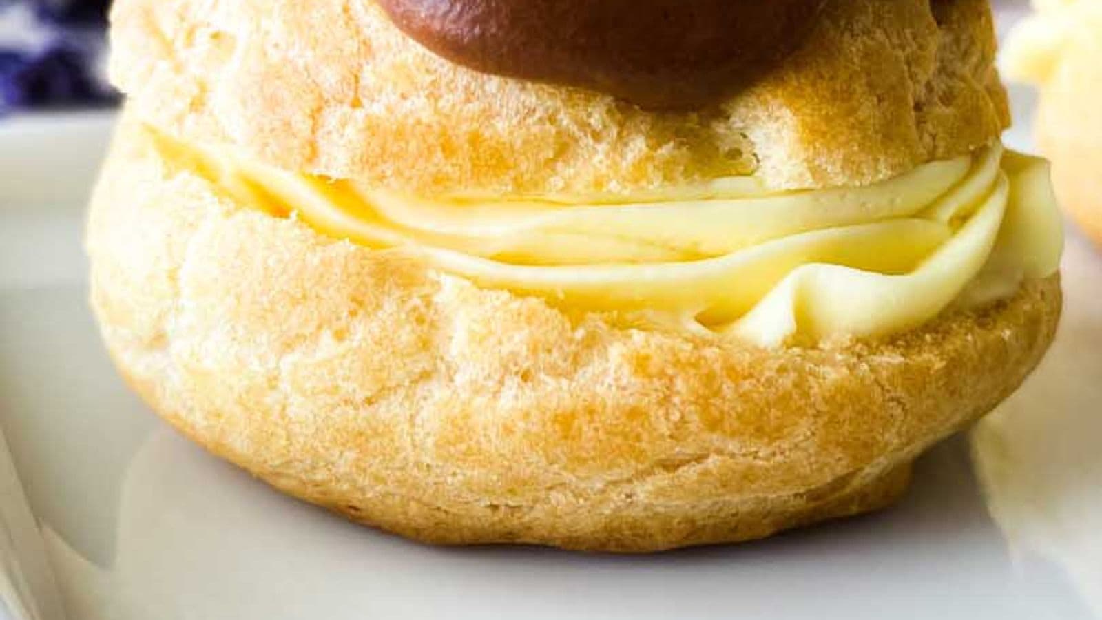 chocolate eclair on a white serving tray