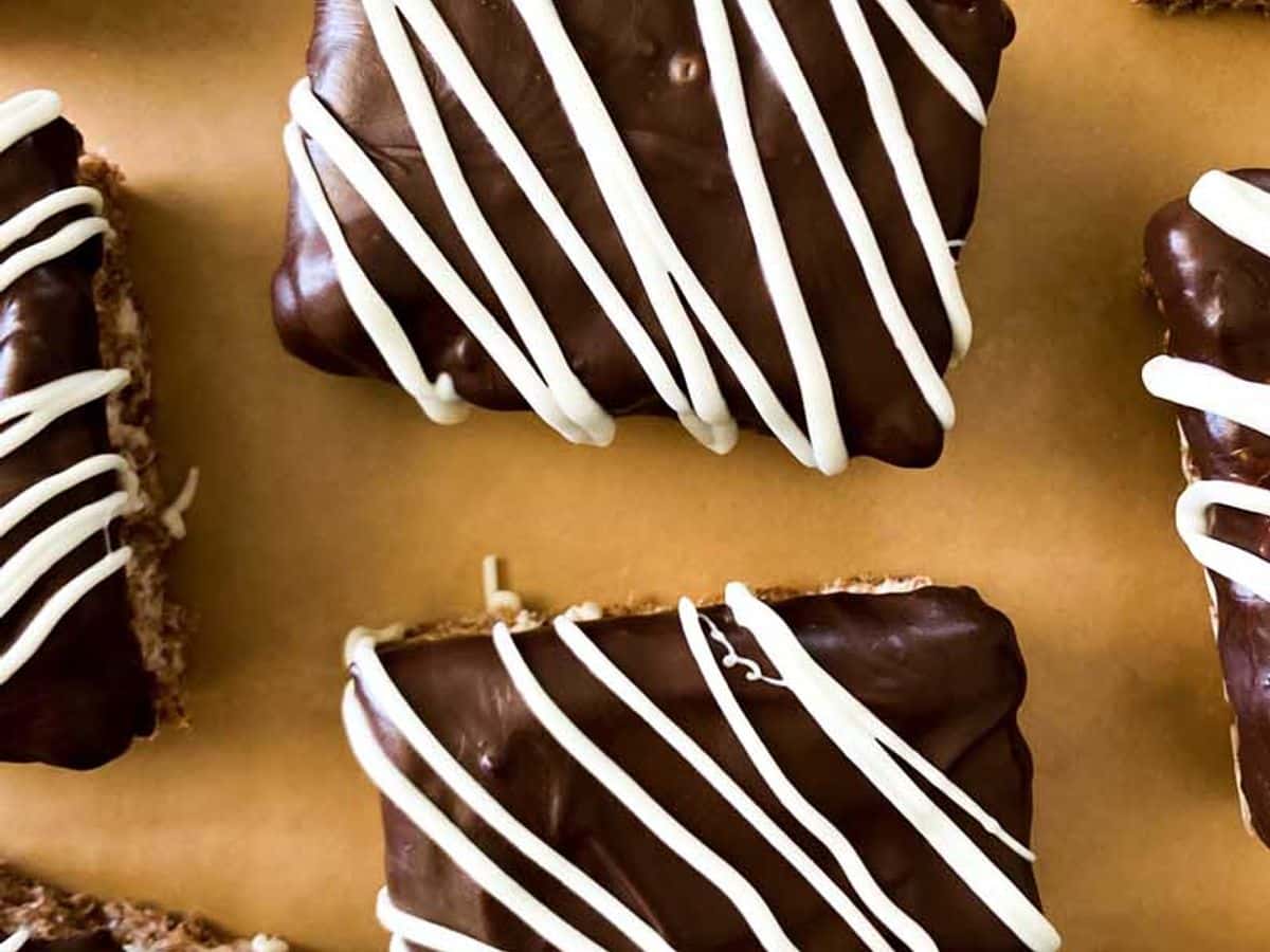 chocolate peanut butter rice krispie treats from overhead showing chocolate coating and white chocolate drizzle