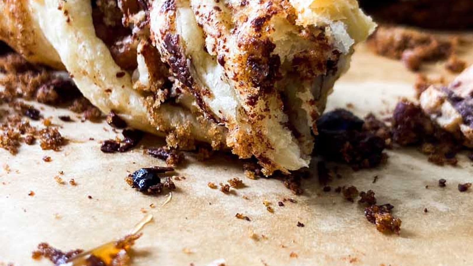 chocolate pecan twists on a counter with a bite taken out of one