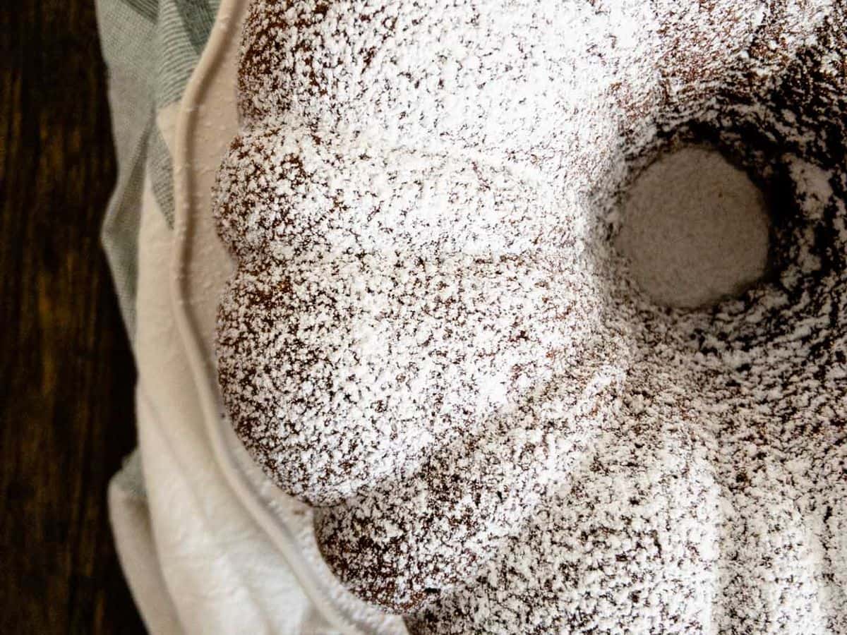 chocolate pound cake baked in bundt cake pan topped with powdered sugar