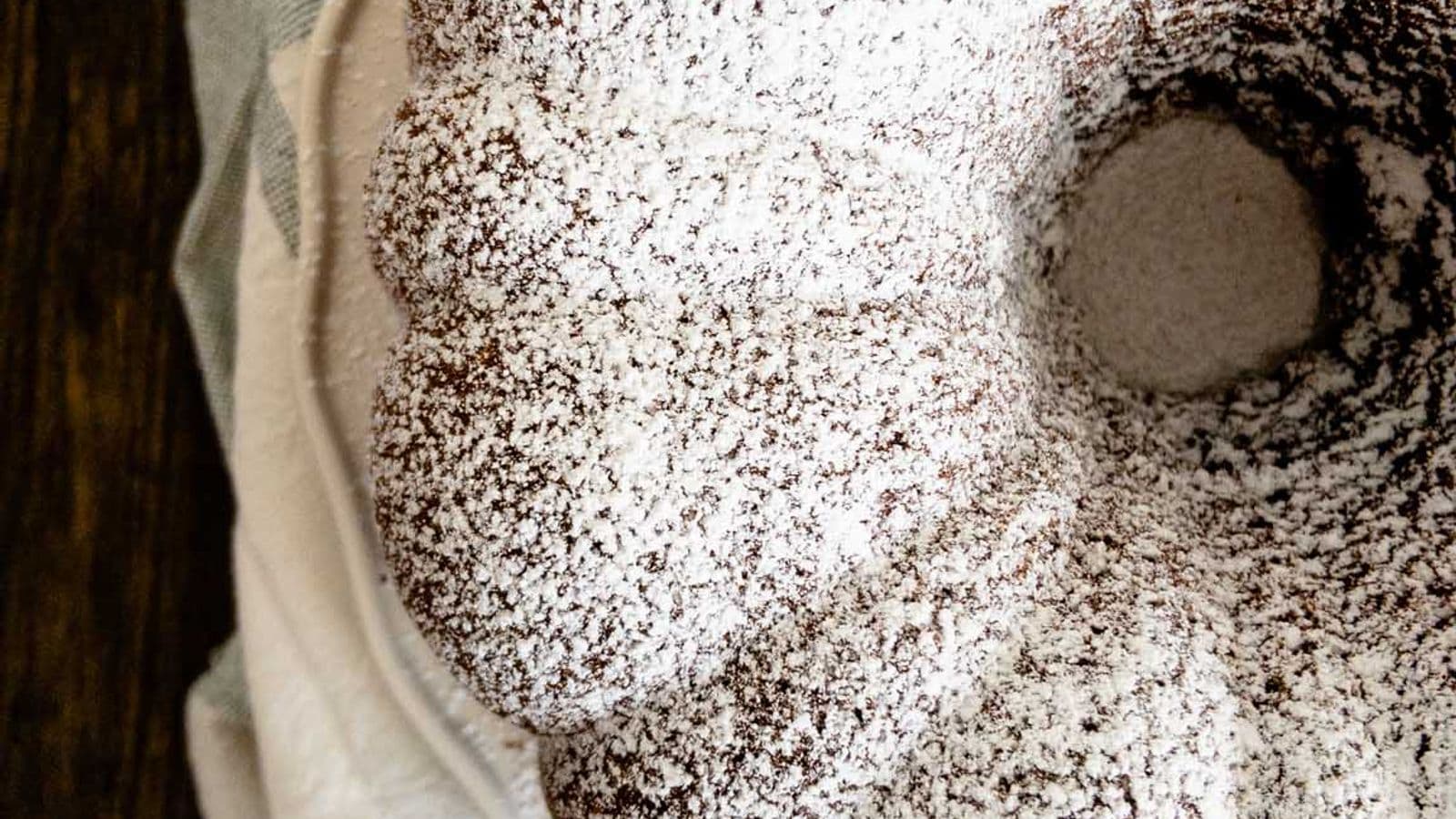 chocolate pound cake baked in bundt cake pan topped with powdered sugar