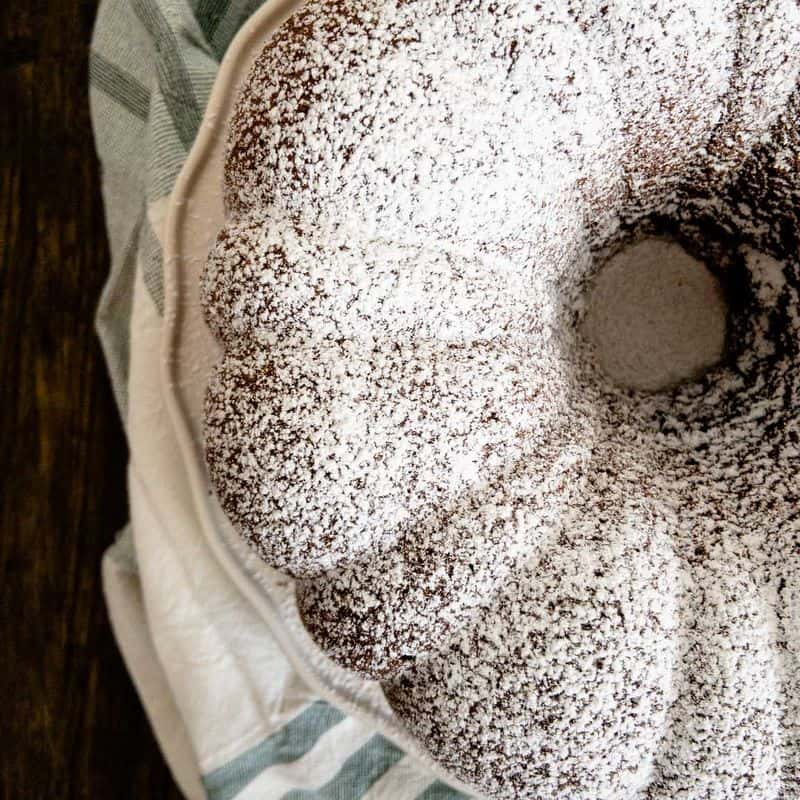 chocolate pound cake baked in bundt cake pan topped with powdered sugar