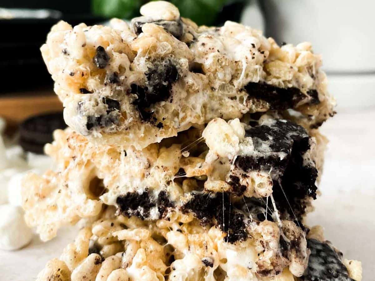 cookies and cream rice krispies stacked with oreo bits and marshmallows