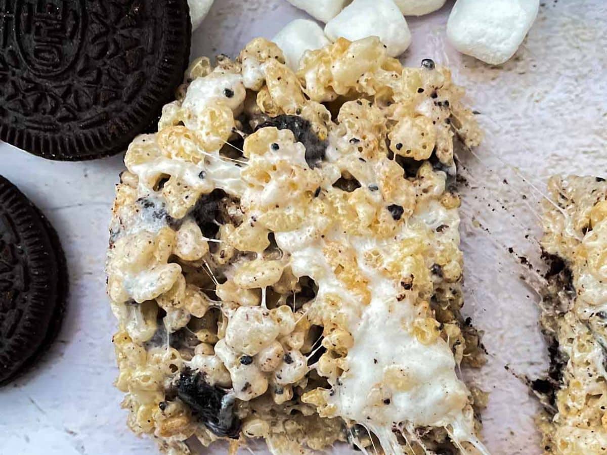 cookies and cream rice krispies single treat being pulled apart with oreos and marshmallows
