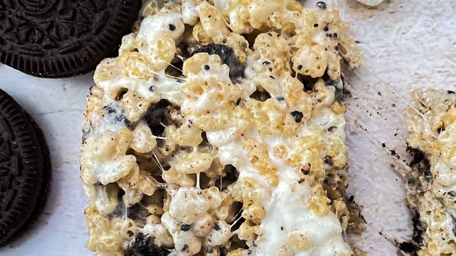 cookies and cream rice krispies single treat being pulled apart with oreos and marshmallows
