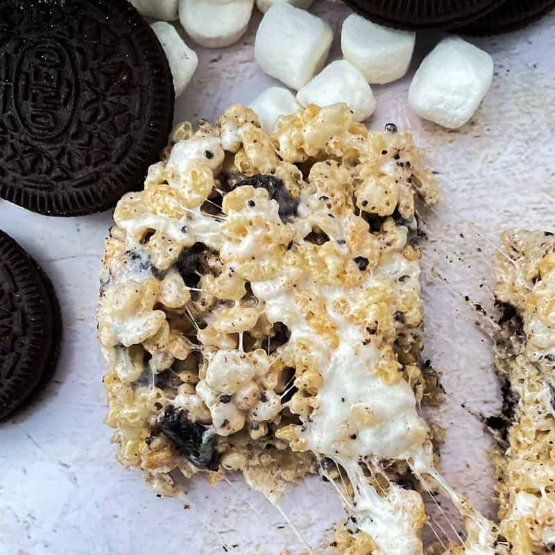 cookies and cream rice krispies single treat being pulled apart with oreos and marshmallows