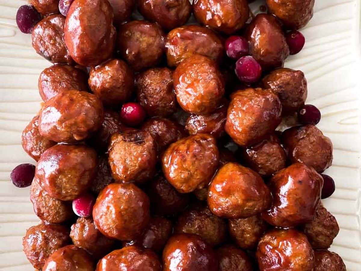 overhead view of meatballs in cranberry sauce on serving platter