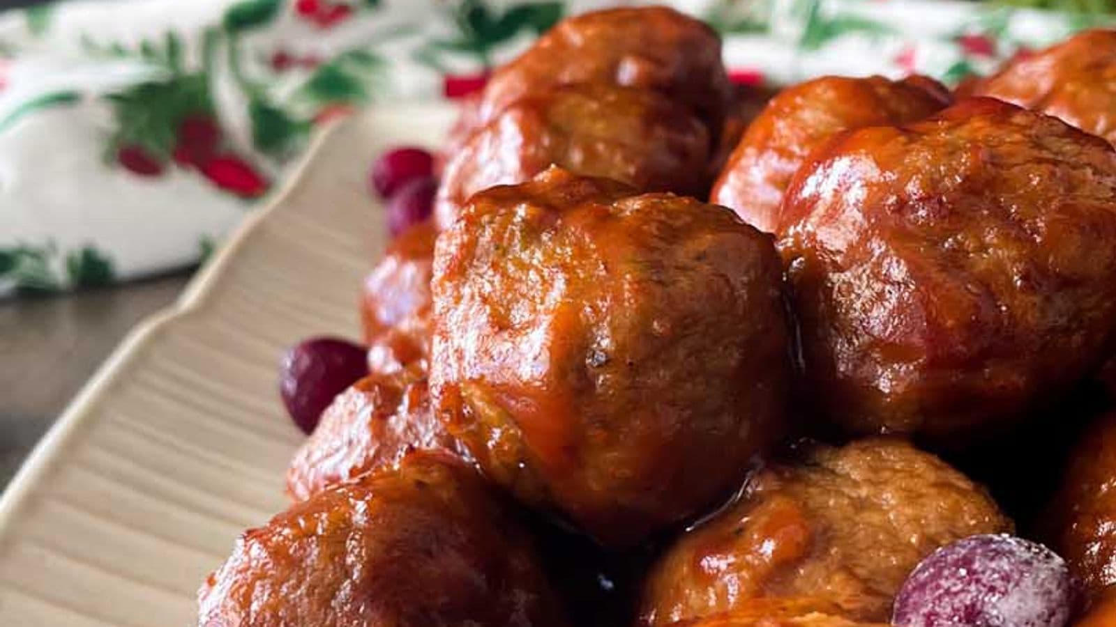 side view of meatballs in tangy cranberry sauce