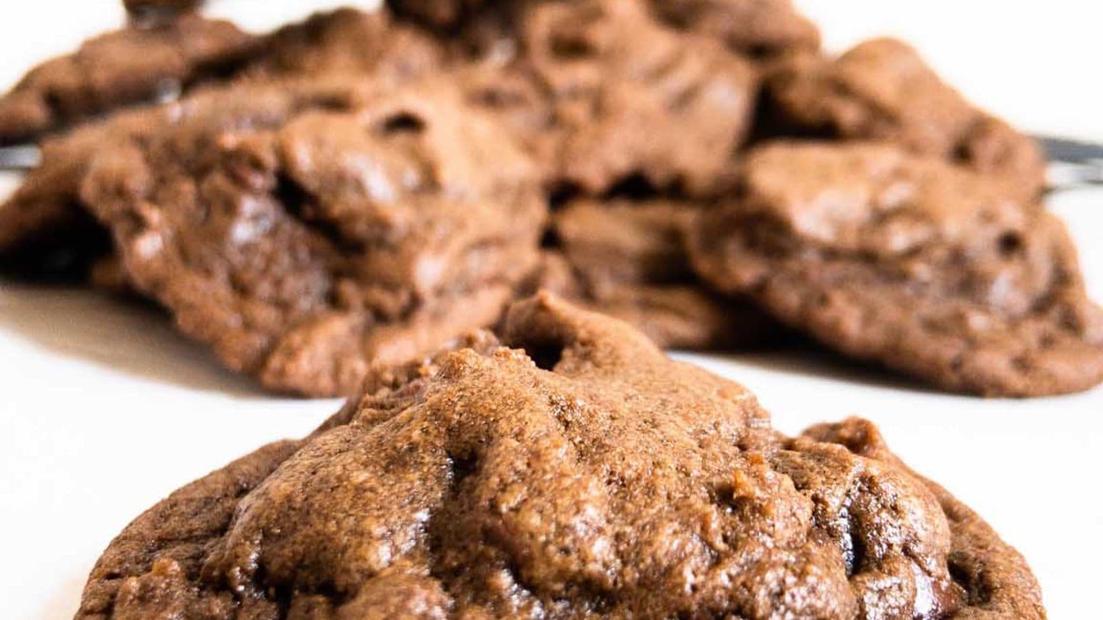 double chocolate chip cookies close up of single cookie with other cookies blurred in background