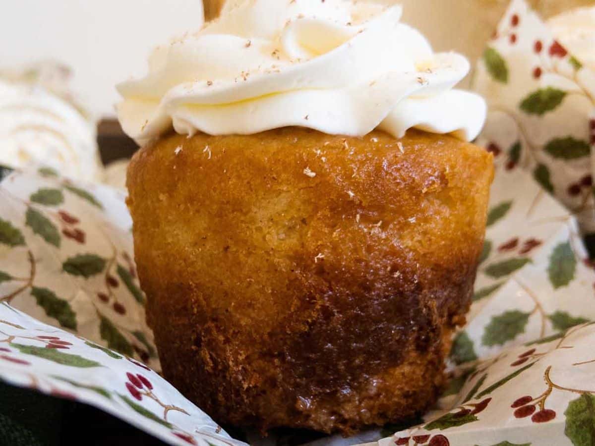 egg nog (tres leches) cupcake topped with mascarpone and grated nutmeg, cupcake liner removed