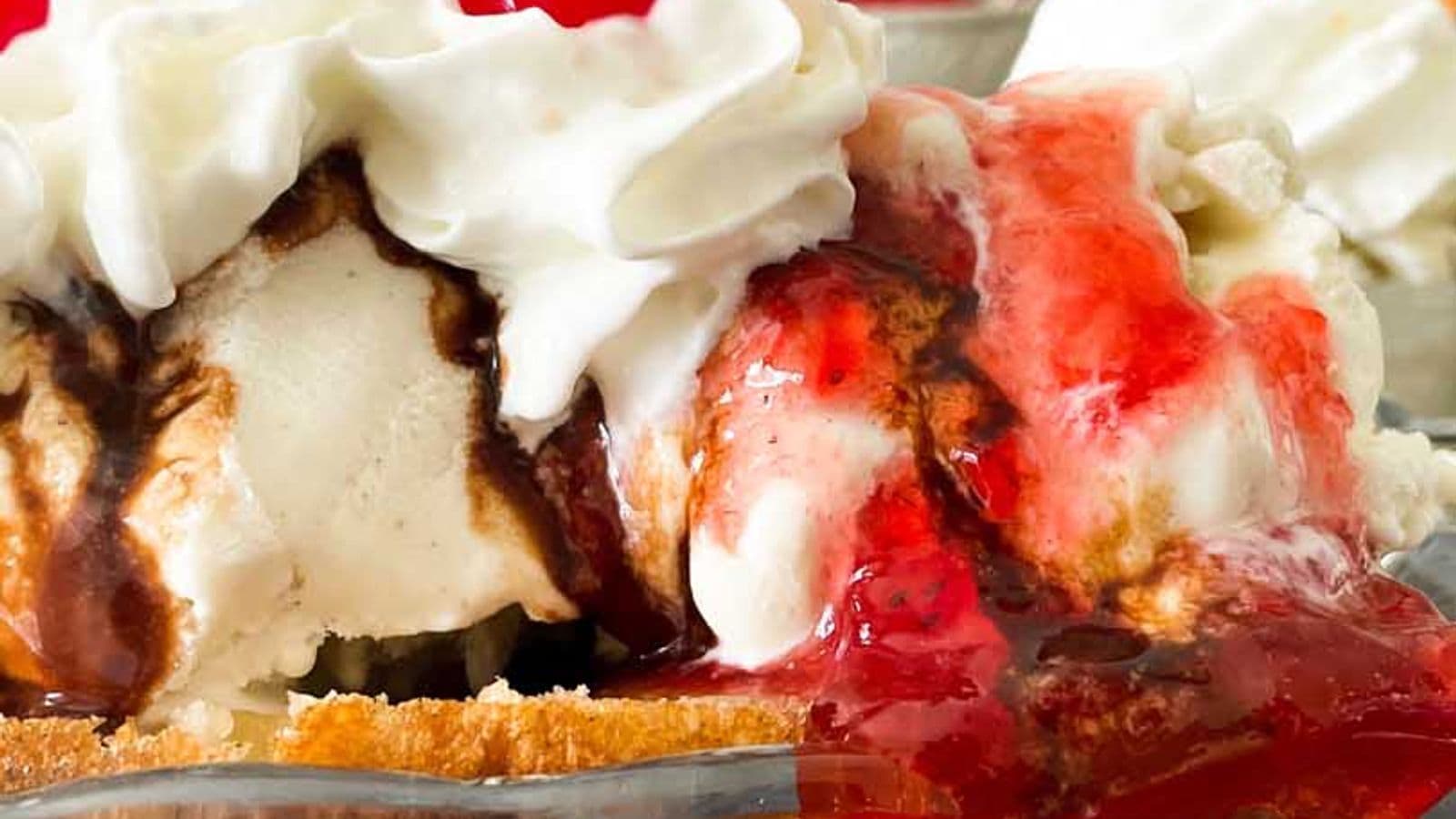 side view of deep fried banana split with ice cream, whipped cream, and cherries
