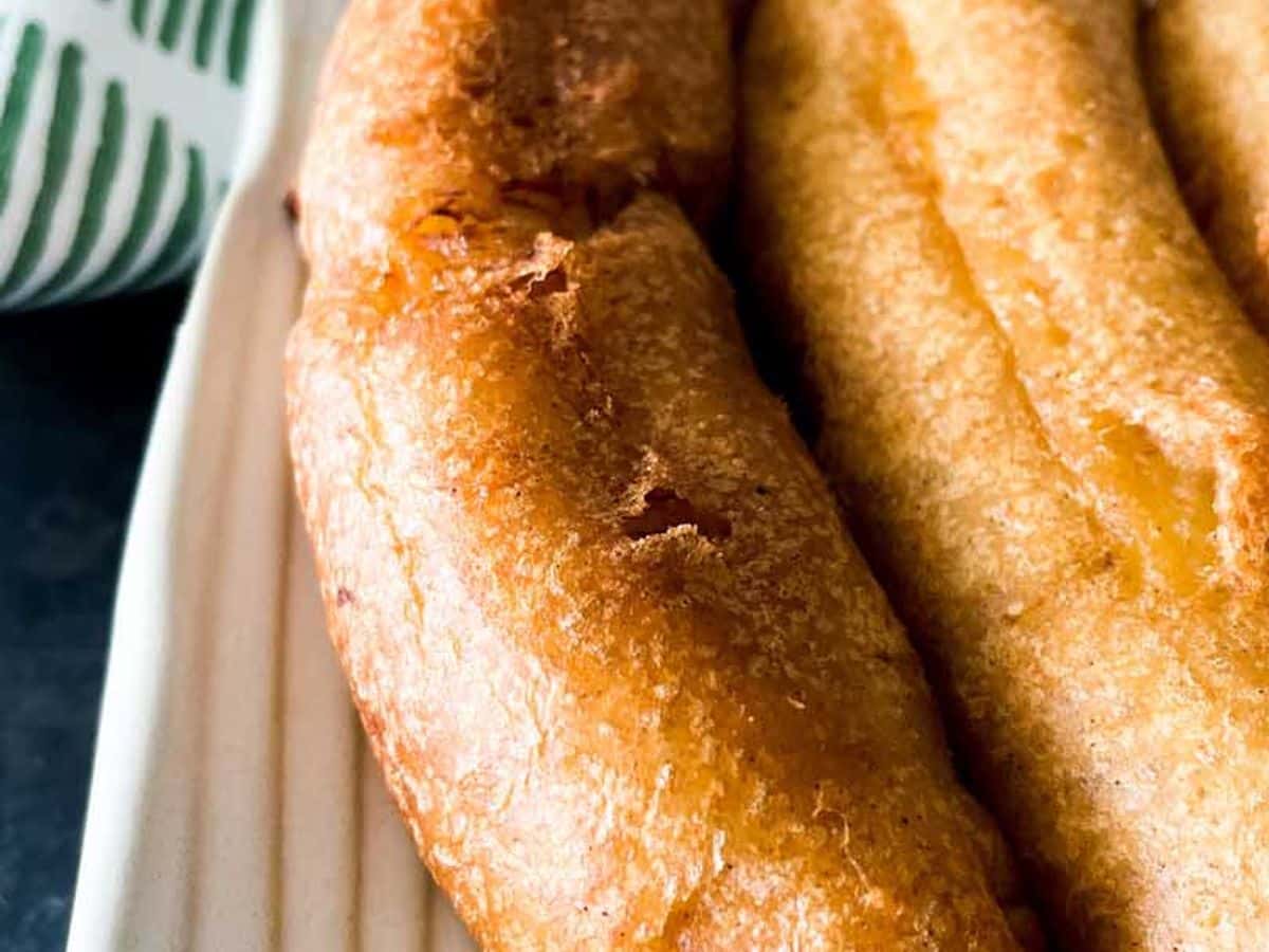 two deep fried bananas on a plate