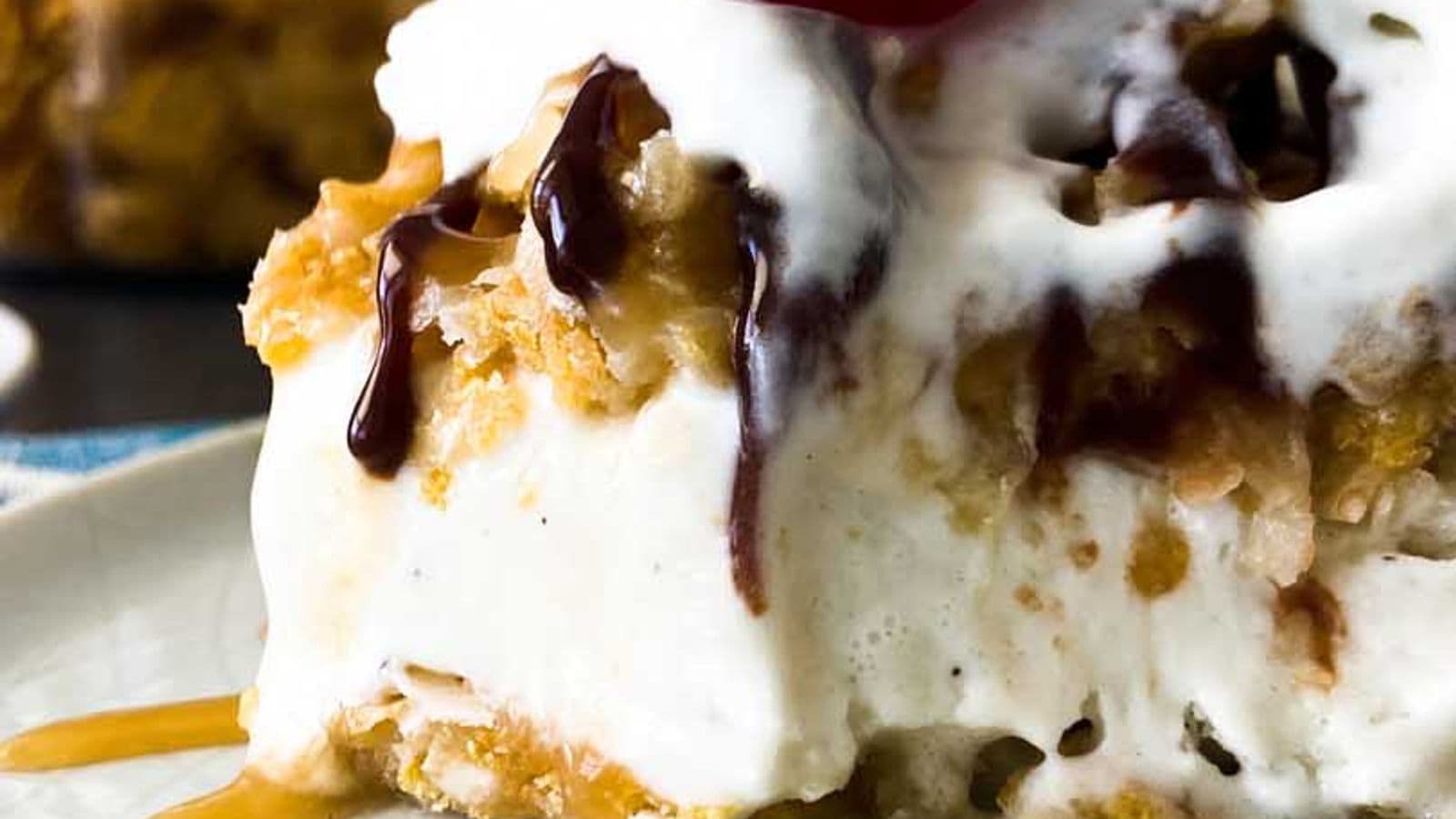 fried ice cream on a plate with chocolate syrup, whipped cream, and a cherry on top
