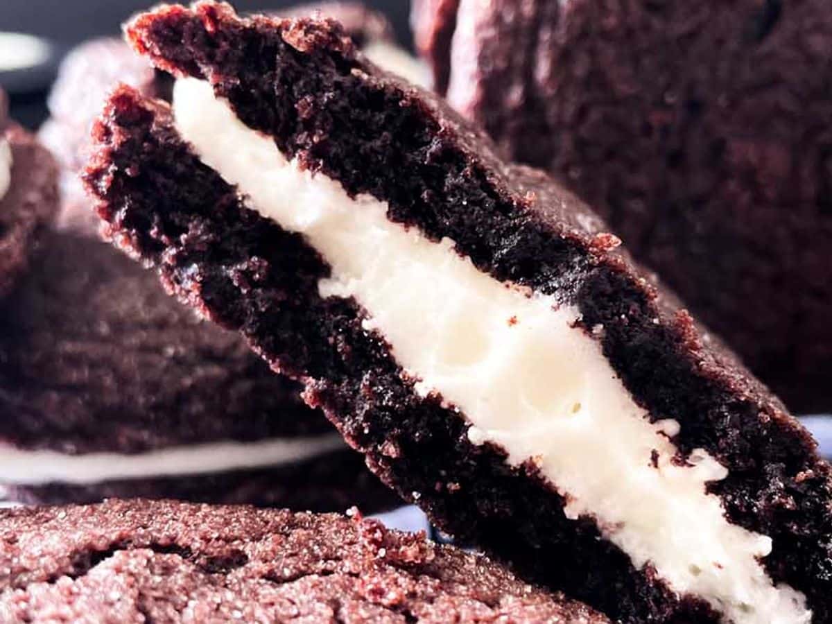 homemade oreo cookies with mascarpone filling close up of cookie broken in half showing filling