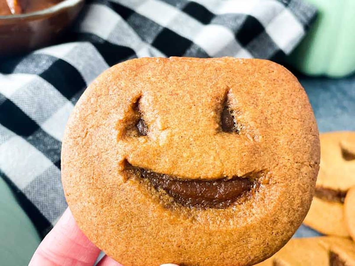 jack o lantern cookie (little debbie pumpkin delight copycat) being held in hand