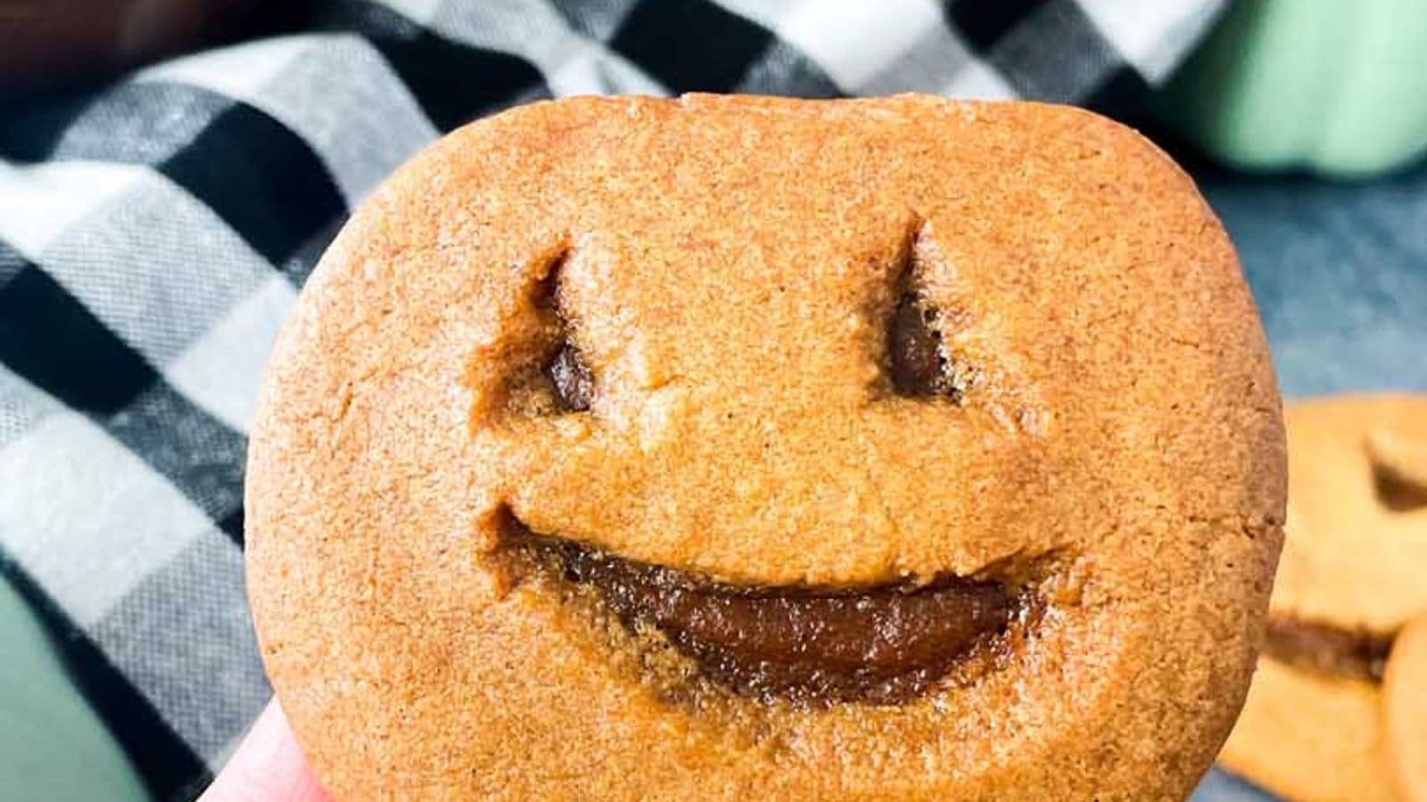 jack o lantern cookie (little debbie pumpkin delight copycat) being held in hand