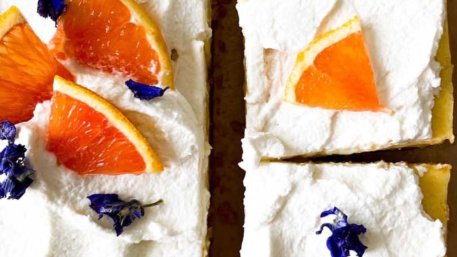 orange bars with honey whipped cream, topped with orange slices and cut into pieces