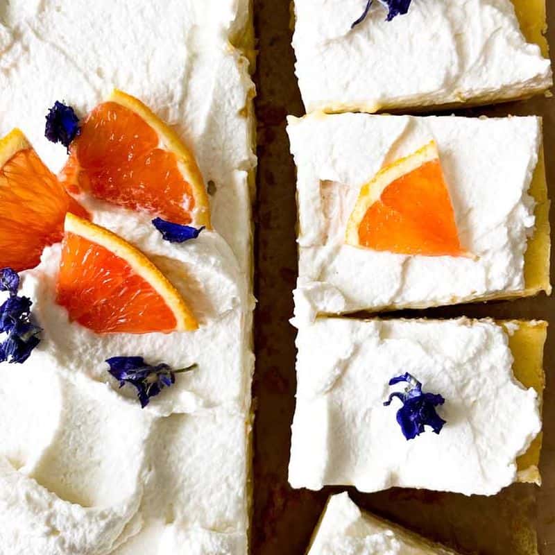 orange bars with honey whipped cream, topped with orange slices and cut into pieces
