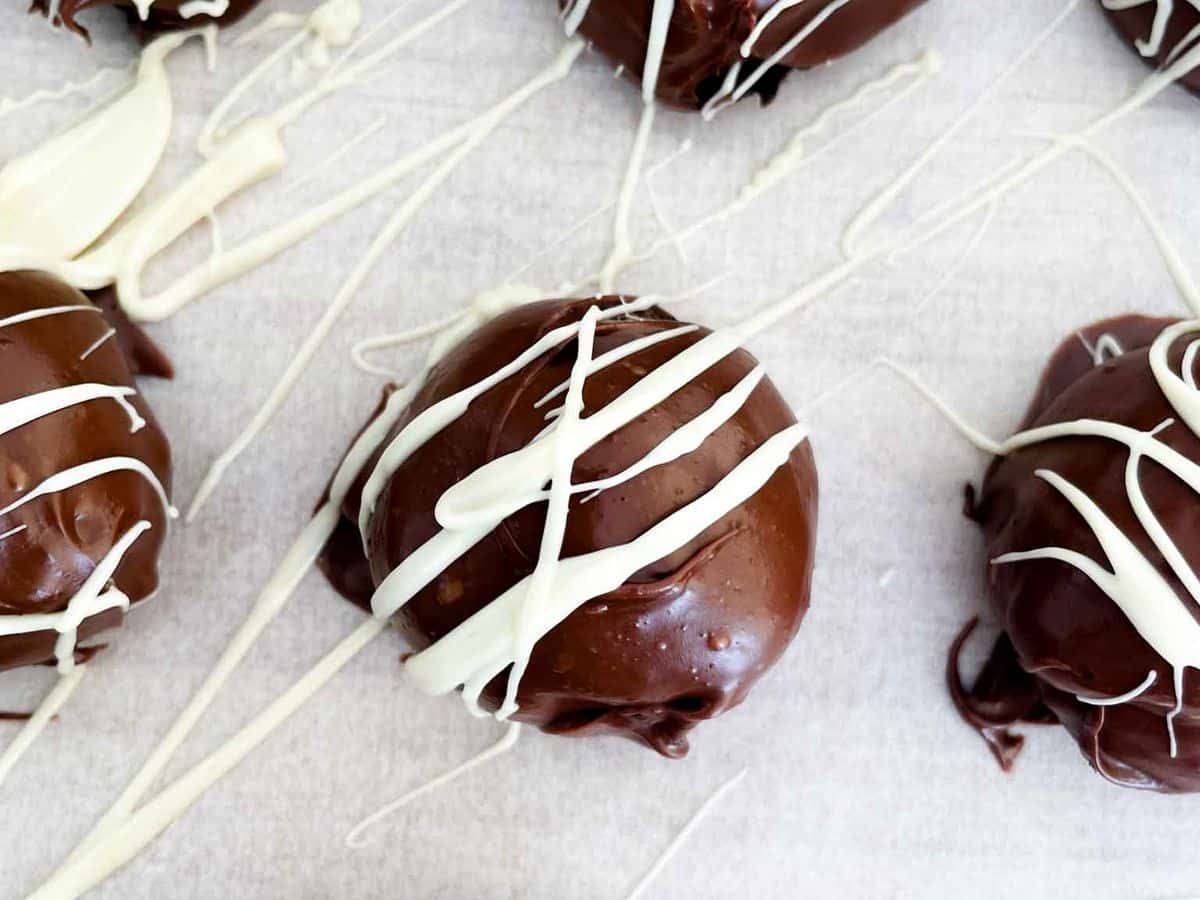 oreo truffles with a white chocolate drizzle