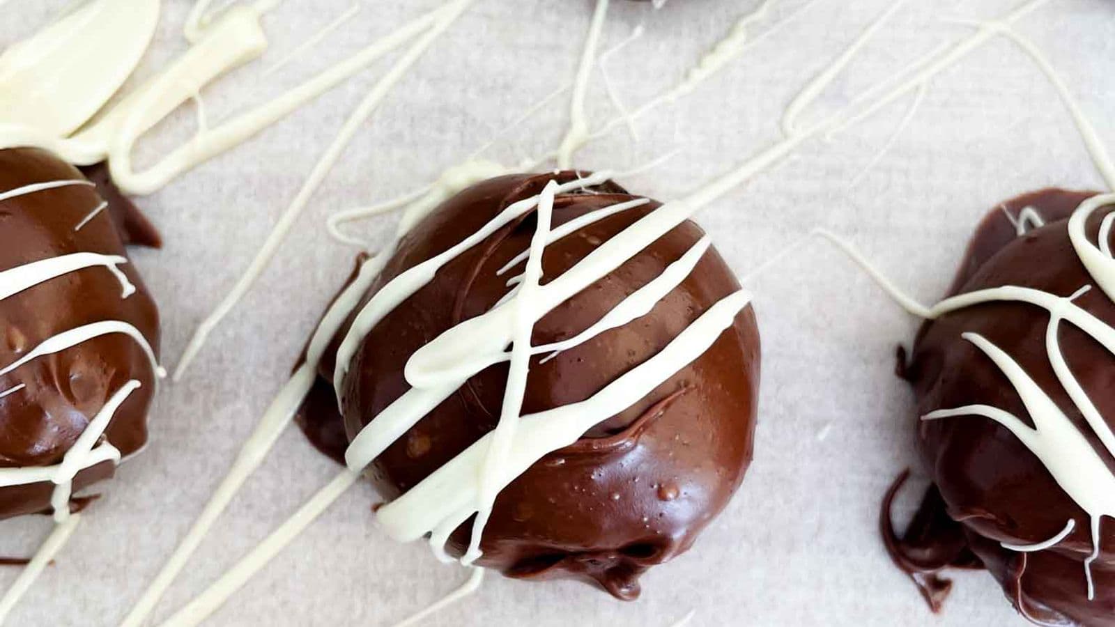 oreo truffles with a white chocolate drizzle