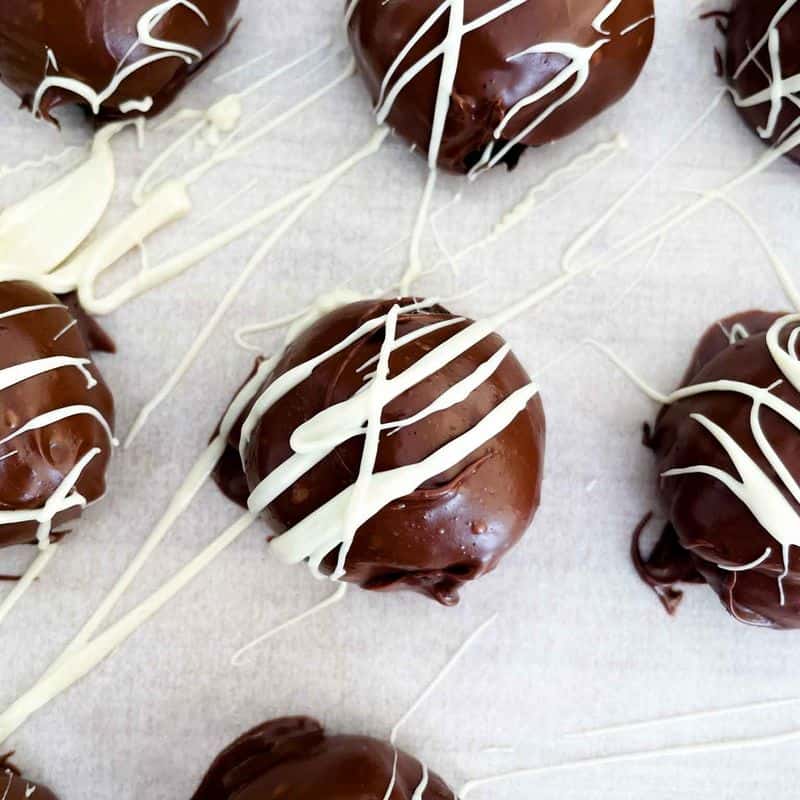 oreo truffles with a white chocolate drizzle