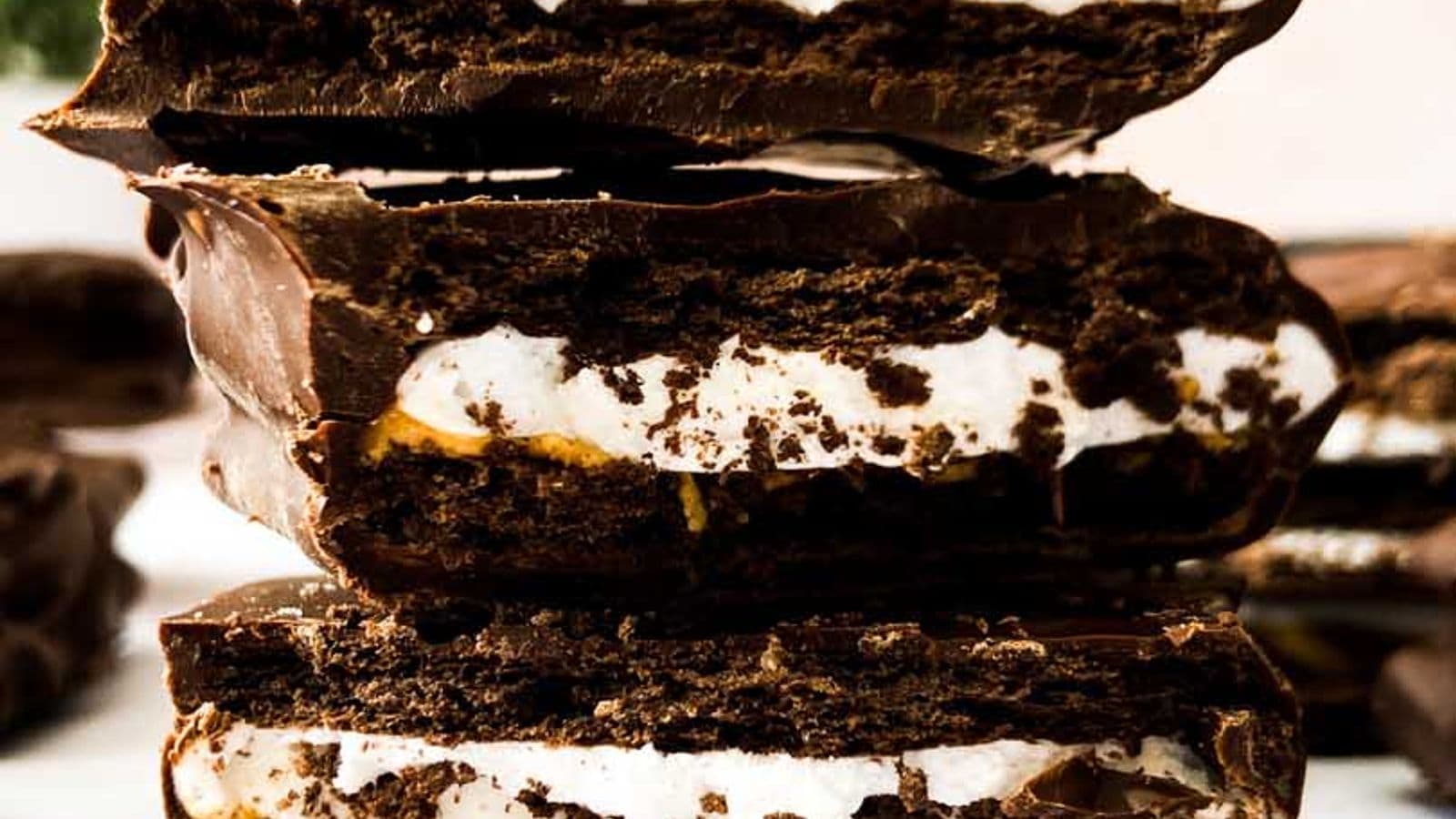 peanut butter smores bars broken in half and stacked on top of each other