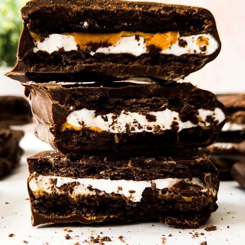 peanut butter smores bars broken in half and stacked on top of each other