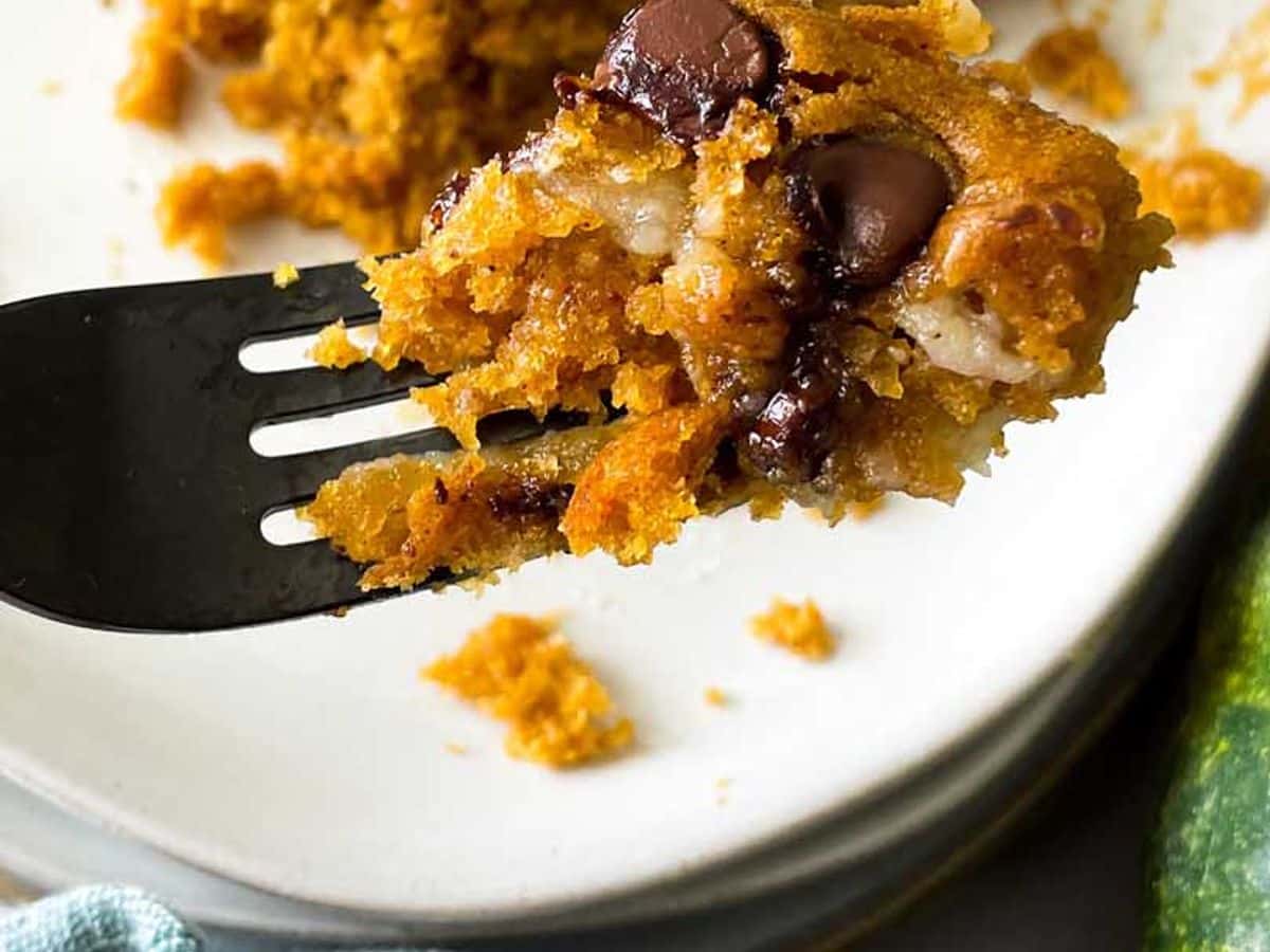 bite of pumpkin cake with cream cheese filling and chocolate chips on a fork