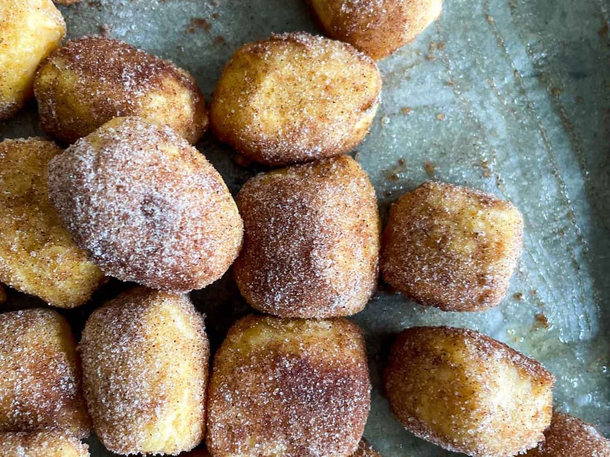 pumpkin pretzel bites on a parchment lined baking sheet