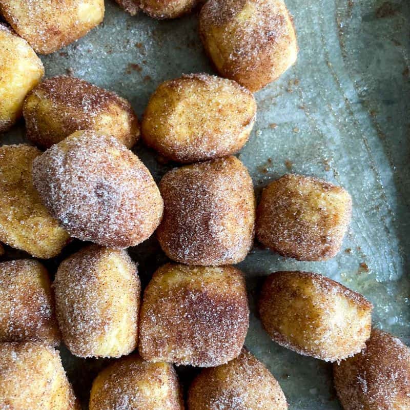 pumpkin pretzel bites on a parchment lined baking sheet
