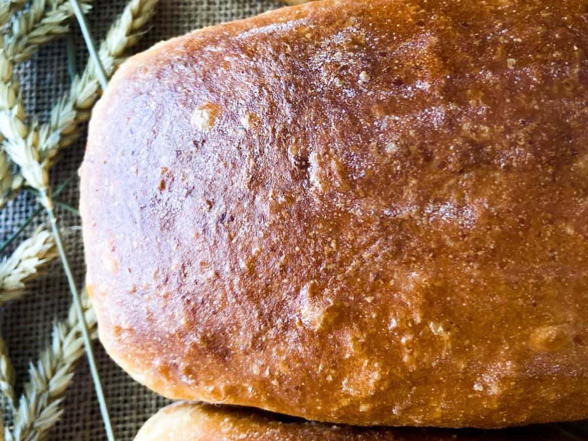three whole sourdough bread loaves with golden brown crust