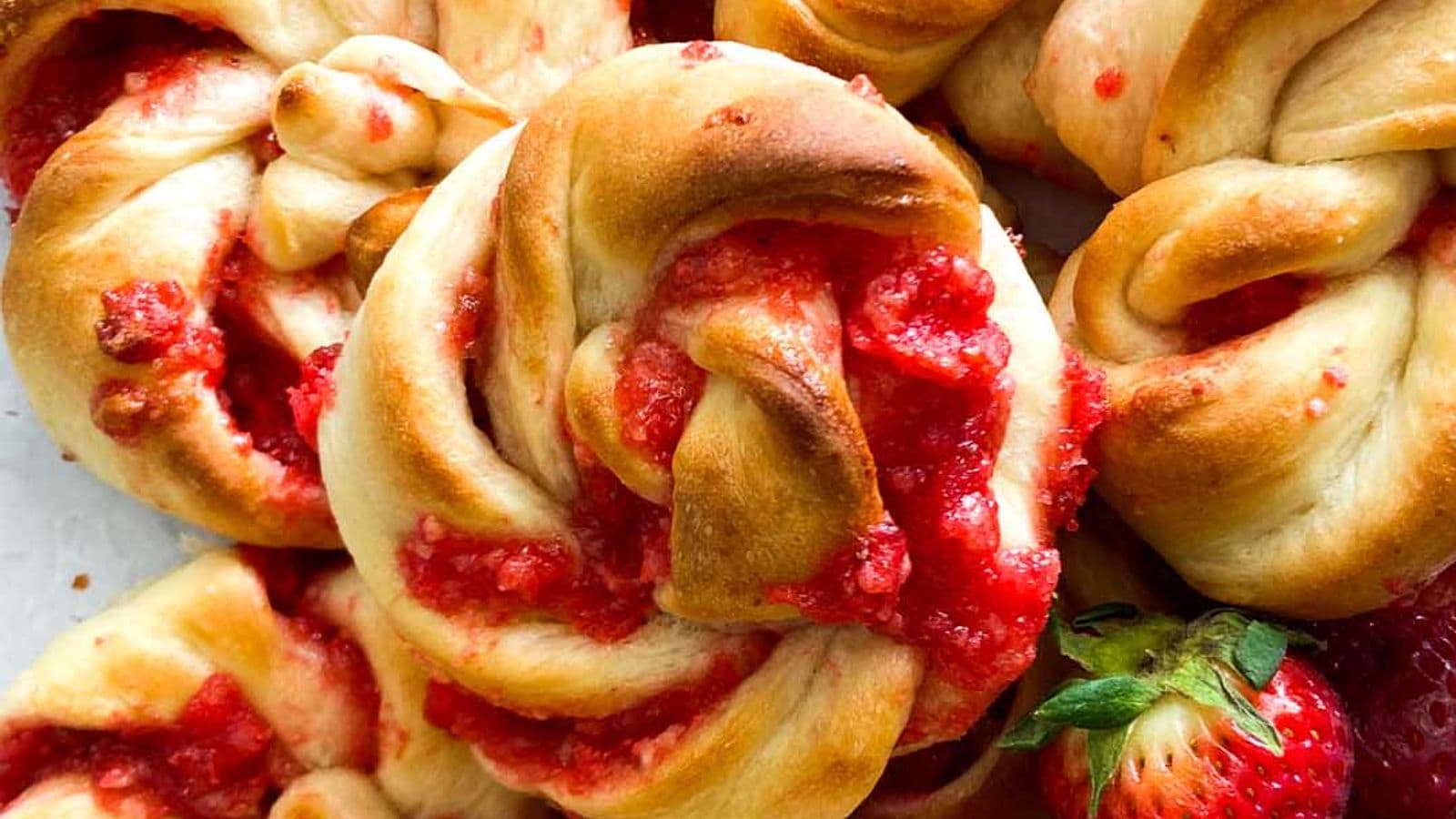 strawberry knots bread rolls piled up with fresh strawberries